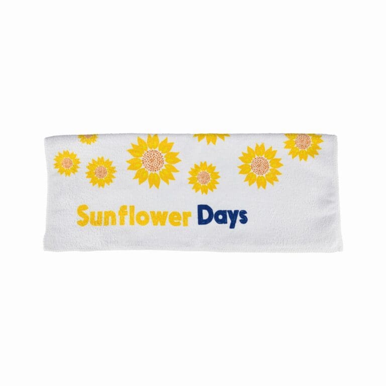 This towel is embellished with multiple bright yellow sunflowers that radiate a warm and inviting aura, reminiscent of sunny days. Each sunflower is detailed with a rich golden yellow hue for the petals and a brown center, creating a realistic and vibrant appearance.